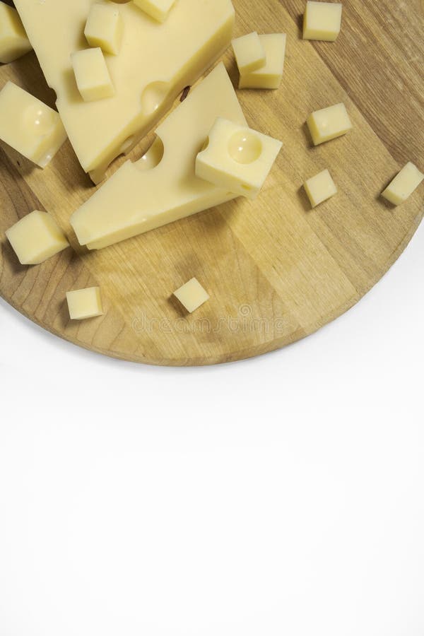 Sliced Emmental Cheese on a Cutting Board. Vertically, from Above on a White Background Stock
