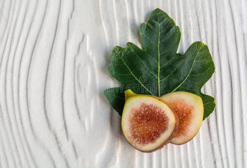 Sliced figs and fresh leaf-black genoa gene stock image
