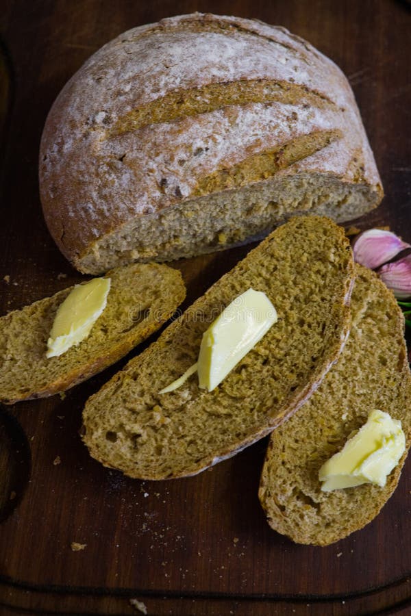 Sliced Fresh Bread with Slices of Butter and Garlic Cloves Stock Photo Image of cereal, baker