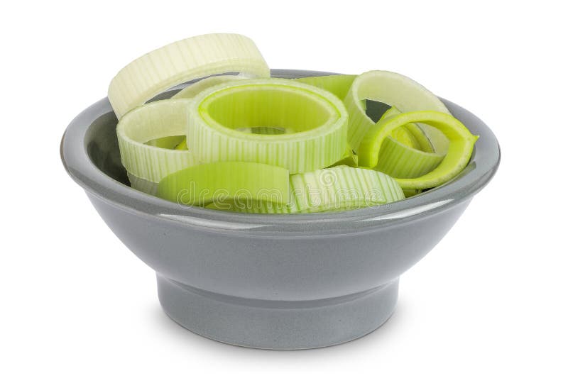 Sliced Leek vegetable in ceramic bowl isolated on white background with full depth of field stock photo