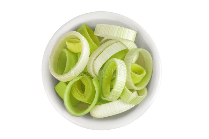 Sliced Leek vegetable in ceramic bowl isolated on white background. Top view. Flat lay stock images