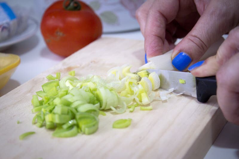 Sliced leek on a wooden cutting board stock photo