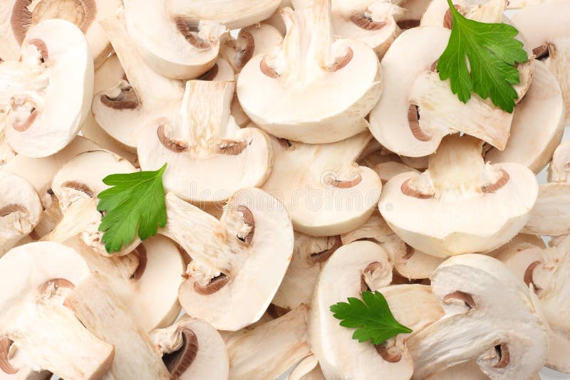 Sliced mushrooms with parsley leaves as background texture. healthy food royalty free stock images Sliced mushrooms with parsley leaves as background texture. healthy food royalty free stock images