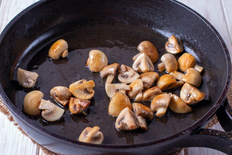 Sliced mushrooms stir-fried in a pan. close-up royalty free stock photos Sliced mushrooms stir-fried in a pan. close-up royalty free stock photos