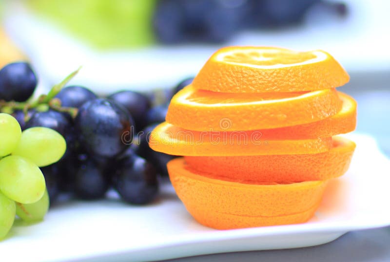 Sliced Orange With Grapes In The Background A Variety Of Delicious Food