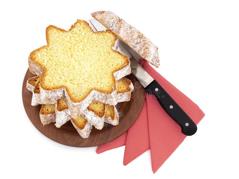 Sliced pandoro, Italian sweet yeast bread, traditional Christmas treat. With red serviettes and knife on white. Overhead