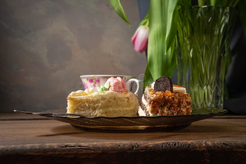 Sliced Pieces of Biscuit Puff Cakes on a Plate with a Cup of Tea Stock