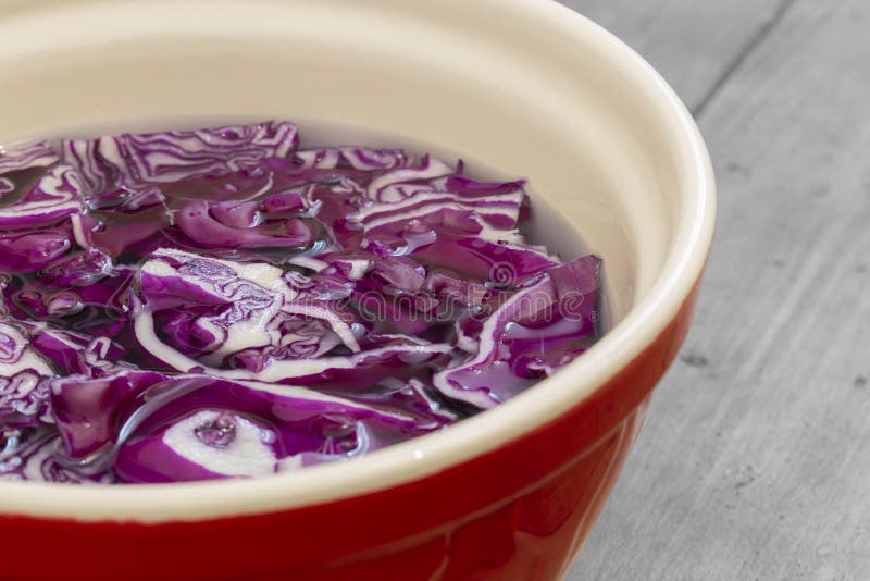 Sliced Red Cabbage Soaking in Water in a Ceramic Bowl. Stock Image