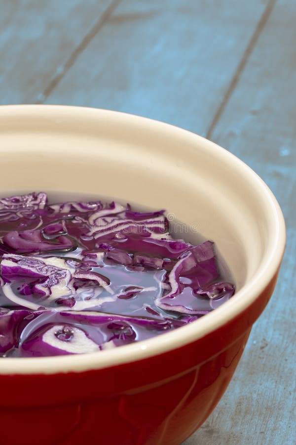 Sliced Red Cabbage Soaking in Water in a Ceramic Bowl. Stock Photo