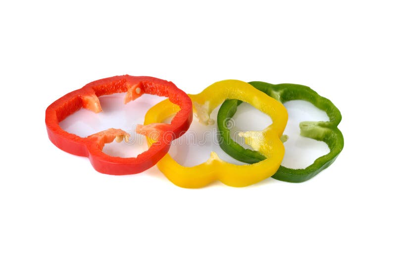 Sliced red yellow green bell pepper on white