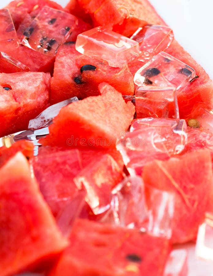 Sliced refreshing red melon and ice cubes