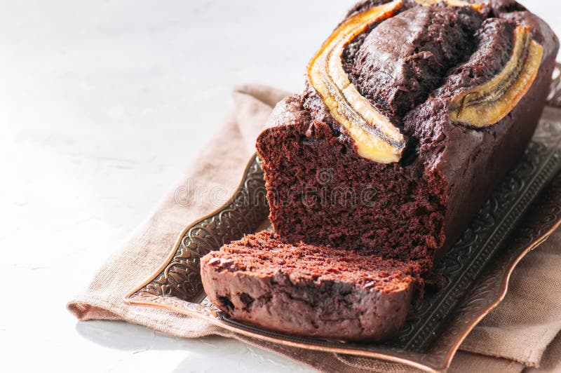 Sliced rich chocolate banana date bread on a vintage tray on a w