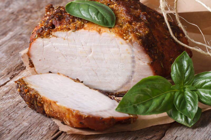 Sliced Roast Pork Tenderloin and Basil Closeup Horizontal Stock Photo