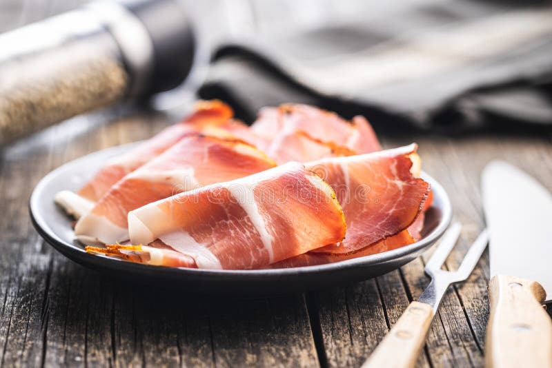Sliced Schwarzwald Ham. Dried Prosciutto Ham on Plate Stock Image