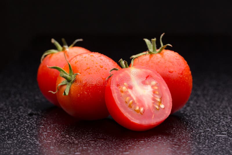 Sliced tomato on a dark background