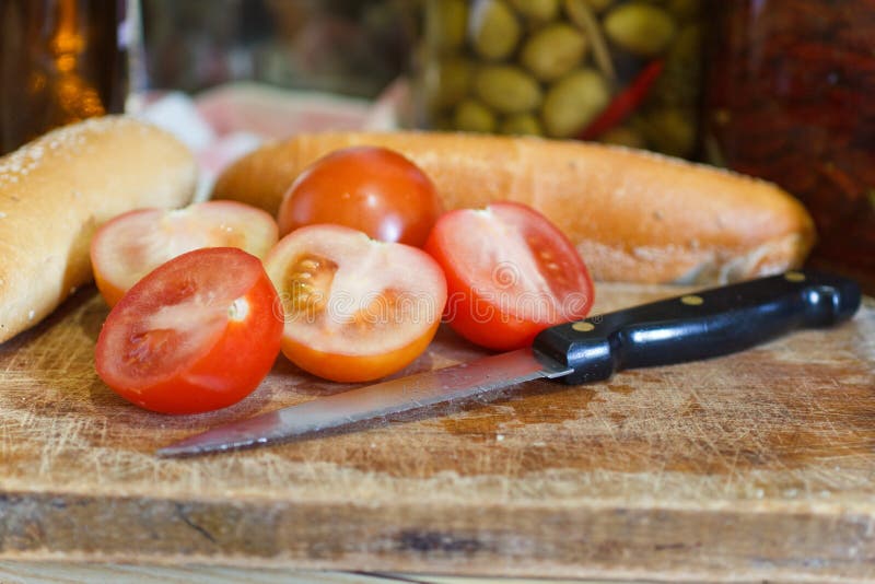 Sliced tomato and knife stock image. Image of green, metal 18448593
