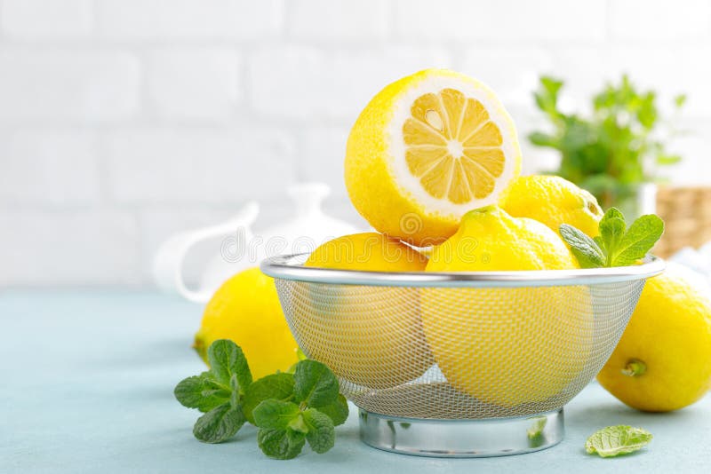 Sliced and whole lemons with mint stock photo