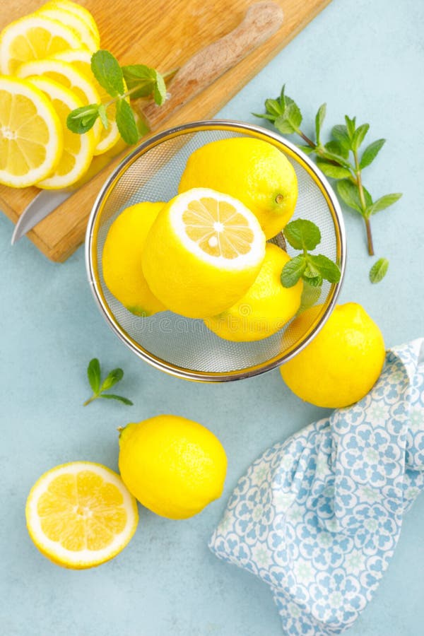 Sliced and whole lemons with mint stock image