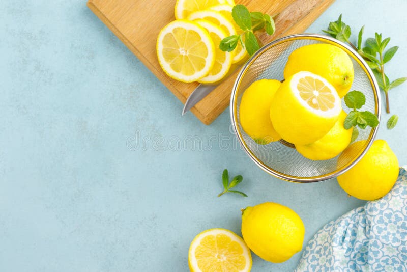 Sliced and whole lemons with mint stock photo
