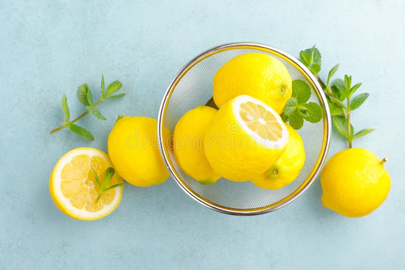 Sliced and whole lemons with mint royalty free stock photos