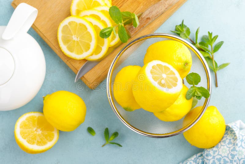 Sliced and whole lemons with mint stock photo