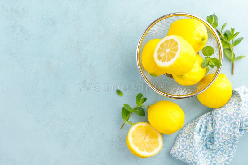 Sliced and whole lemons with mint stock photography