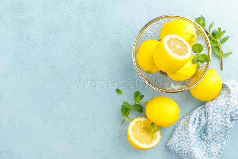 Sliced and whole lemons with mint stock images