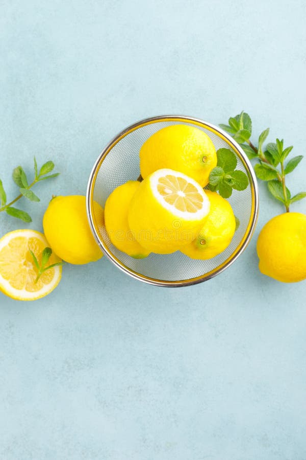 Sliced and whole lemons with mint stock photography