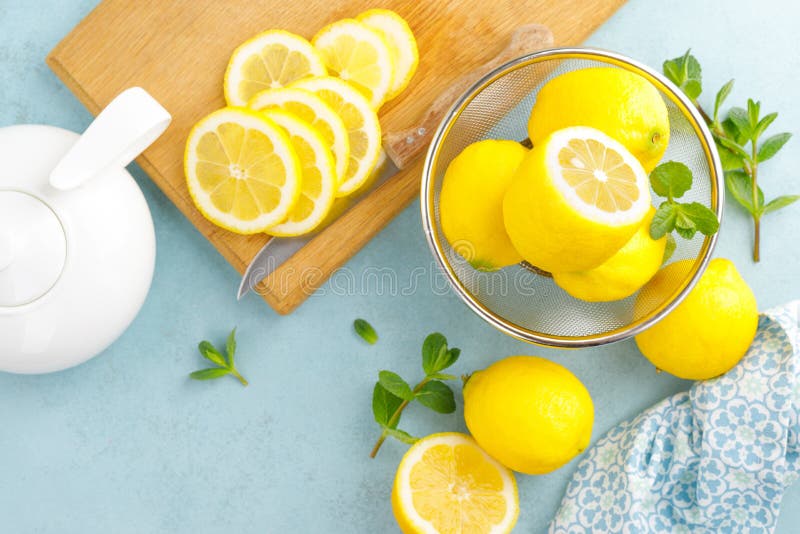 Sliced and whole lemons with mint royalty free stock images