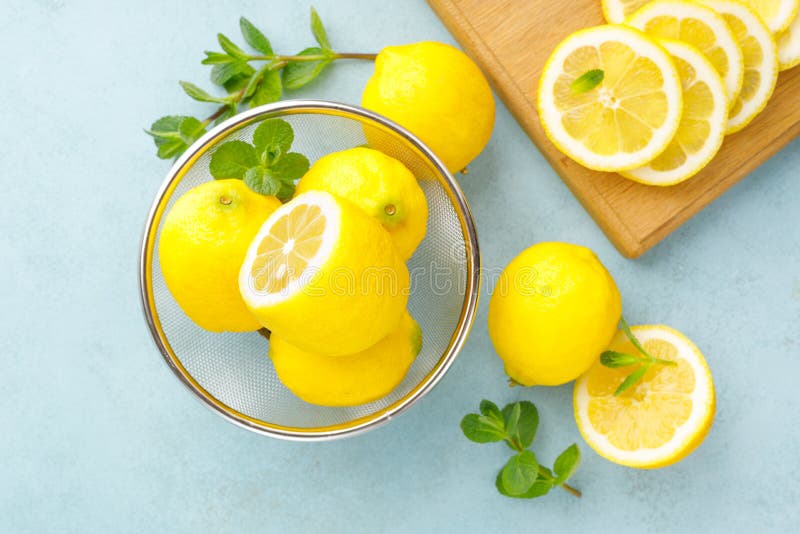 Sliced and whole lemons with mint royalty free stock photo