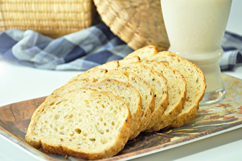 Wholewheat Breads with Cheese, Jams and Green Olives on a Wooden