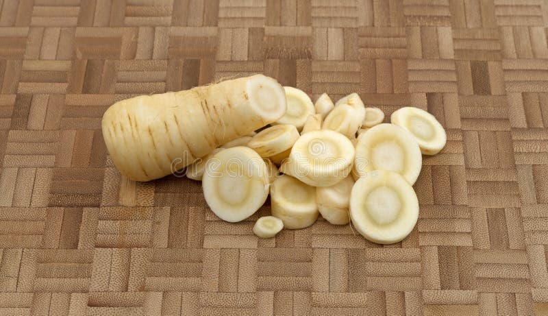 Slices of parsnip on a wood cutting board royalty free stock photography