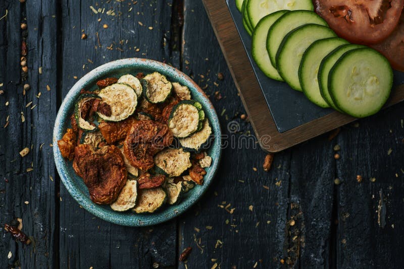 Slices of raw and dried tomato and zucchini