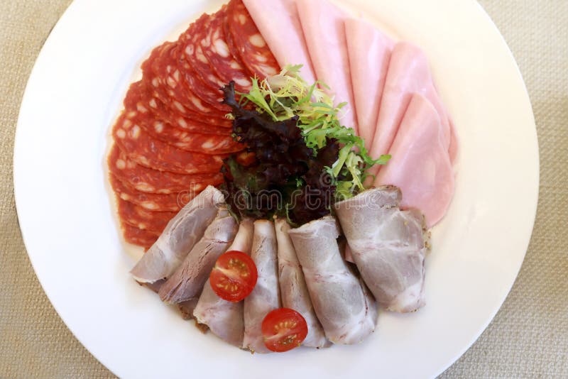 Slices various meat on plate royalty free stock photo