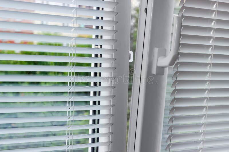Slightly Open Modern Plastic Window with Horizontal Blinds Stock Image