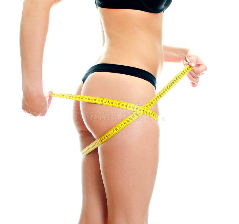 Slim Female Body with Measure Tape Around Hips. Stock Photo