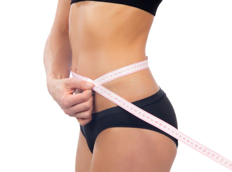 Slim woman measuring her waist metric tape measure