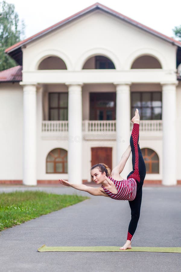 beautiful slim woman in yoga pants standing on porch Stock Photo