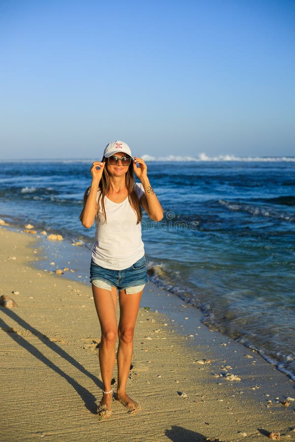 Slim Young Woman Walking Barefoot Along the Beach. Caucasian Woman ...