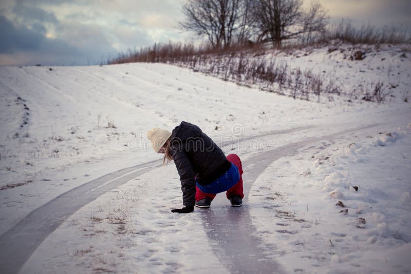 Slip on the slippery ice and snow on the road track at the country in freezing winter day