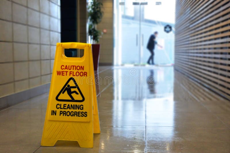 Slippery floor surface warning sign and symbol on a wet floor