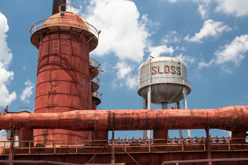 Sloss Furnaces National Historic Landmark, Birmingham Alabama USA, wide view of furnace and water tower against a brilliant blue s