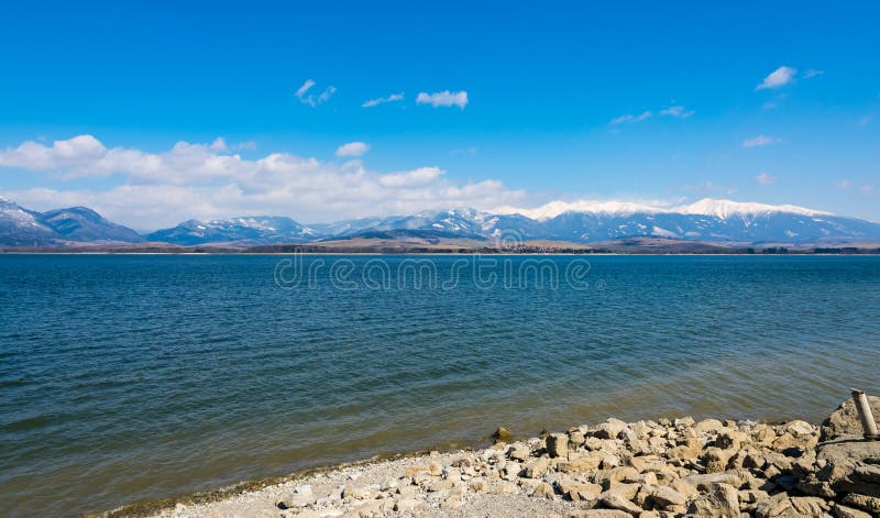 Slovakia: Liptovska Mara lake with the tatra mountains in the background. Winter mountains, clouds. royalty free stock image Slovakia: Liptovska Mara lake with the tatra mountains in the background. Winter mountains, clouds. royalty free stock image