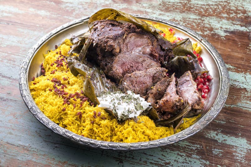 Slow cooked Omani lamb shuwa coated in rub of spices and wrapped in banana leaves with rice and yoghurt