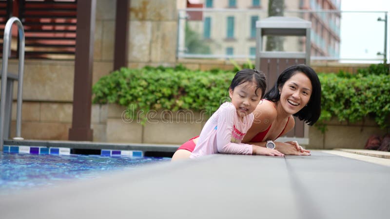 slow motion asian Chinese mother and daughter enjoying at the pool