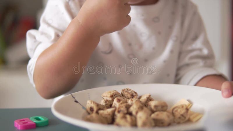 Slow motion Asian Chinese Toddler feeding herself with bread