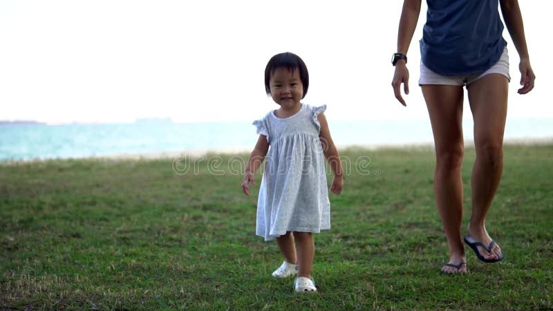 Slow motion of Asian mother and young baby girl walking