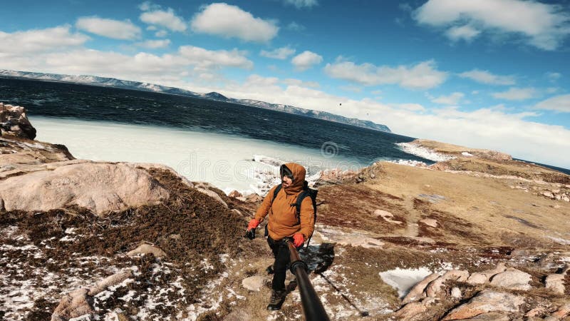 Slow-motion of Hispanic man ascending a snowy mountain in the heart of the Canadian Rockies stock footage