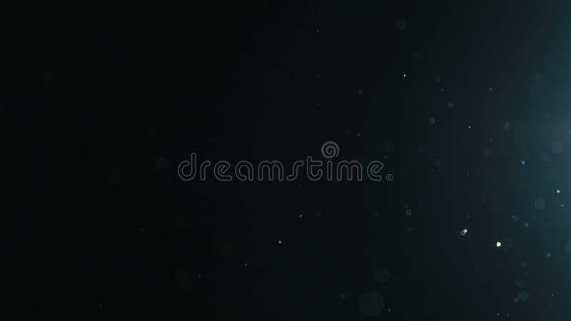 Slow motion natural dust particles float in air on black background stock footage