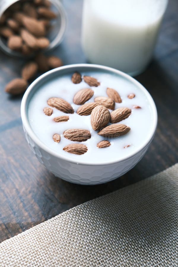 Slow Motion of Pouring Almond Nuts in a Milk Stock Photo Image of